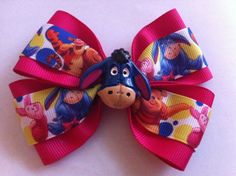 You are looking at a Winnie the Pooh and friends hair bow. There are two layers of grosgrain ribbon. The top ribbon layer has Pooh, Tigger, Eeyore, and Piglet allover. The under layer is in a solid hot pink ribbon. The French barrette is trimmed in a matching hot pink ribbon. There is a decorative Eeyore flat back on the front. The bow is approximately 4" wide and 2 3/4" from top to bottom at the tallest part. This is a handmade item. Free shipping within the US and we also offer priority mail s Minnie Mouse Ribbon, Hot Pink Ribbon, Hair Bows Diy Ribbon, Disney Hair Bows, Winnie The Pooh And Friends, Pooh And Friends, Disney Hair, Girls Hair Bow, Bows Diy Ribbon