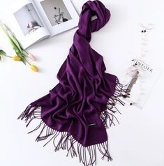 This tasseled oversized cashmere-blend scarf is the perfect piece to keep you warm and stylish this winter while on the go. Can be used as a scarf or a shawl. Branded with company logo. Dimension: 78 x 28 inches Cashmere/Polyester blend Tassels at Hem Care: Dry Clean Brand Logo Elegant Fringe Shawl Scarf, Elegant Fall Pashmina Shawl, Elegant Fringed Shawl Scarf, Elegant Cashmere Shawl Scarf, Elegant Solid Color Winter Scarves, Solid Color Fringe Scarf For Fall, Elegant Fringed Scarves For Fall, Elegant Fall Cashmere Pashmina Shawl, Elegant Winter Shawl Scarves