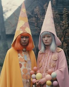 two women dressed in costumes standing next to each other