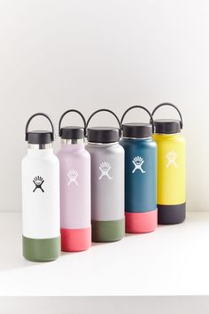 six different colored water bottles with black handles