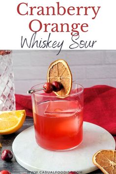 cranberry orange whiskey sour on a white plate