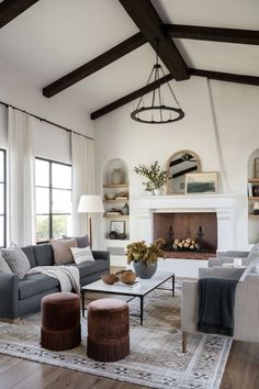 a living room filled with furniture and a fire place in the middle of a room