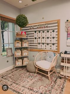 a room with a chair, rug and shelves filled with boxes on the wall next to a window