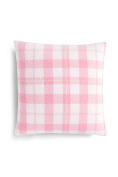 a pink and white plaid pillow on a white background