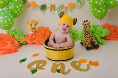 a baby sitting in a bucket surrounded by decorations