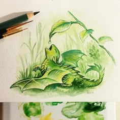 a drawing of a green dragon sitting on top of a leafy plant next to a watercolor pencil