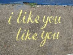 i like you like you written in chalk on the sidewalk next to a blue door