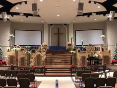 an empty church with pews and decorated stage