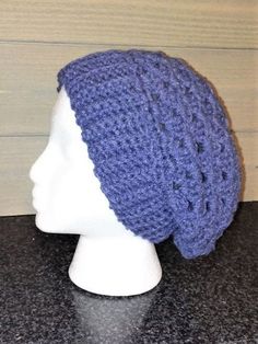 a crocheted hat on top of a white mannequin head