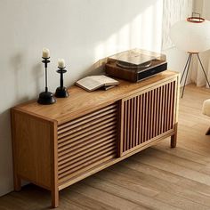 a sideboard with books and candles on it