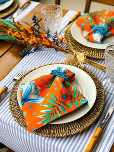 the table is set with orange and blue napkins