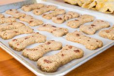 dog biscuits are on a baking sheet ready to be baked in the oven for consumption