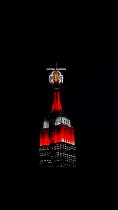 the empire building lit up in red and white