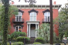 a large red brick house with white trim