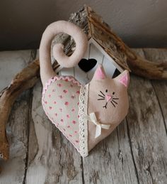 a stuffed cat is sitting next to a birdhouse