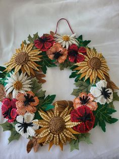 a wreath made out of flowers and leaves