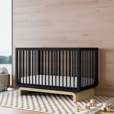 a baby crib sitting on top of a wooden floor next to a wall with wood planks