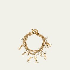 Saint Laurent bracelet featuring four rows with differently shaped links, rhinestone pendants, and YSL charms Brass and glass Toggle clasp closure Made in Italy Ysl Charm Bracelet, Trinket Collection, Saint Laurent Bracelet, Silk Bracelet, Signature Bracelet, Cubic Zirconia Bracelet, Lucky Bracelet, Gold Charm Bracelet, Diamond Charm