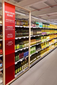 an aisle in a grocery store filled with lots of bottles