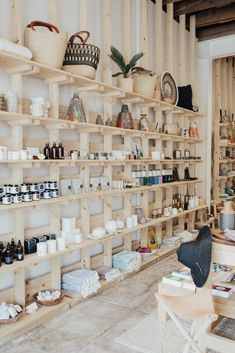 a room with shelves filled with lots of bottles and containers on it's sides