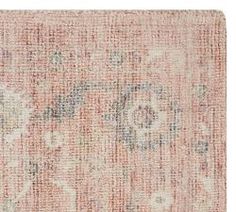 an antique rug with faded colors and floral designs on the bottom, in pink tones