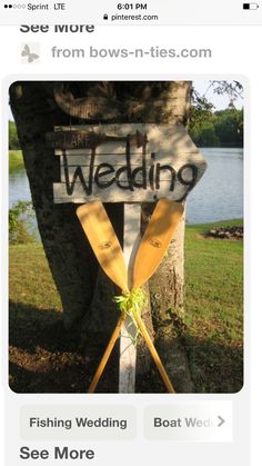 two wooden paddles are tied to a sign