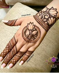 henna tattoo on the palm of a woman's hand