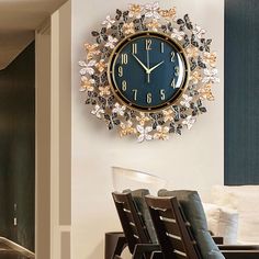 a clock that is on the wall above a dining room table with chairs in front of it