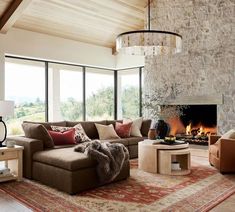 a living room filled with furniture and a fire place in the middle of a room