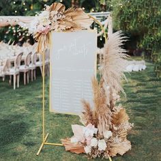 an outdoor seating area is decorated with pamodia, pamolite and feathers