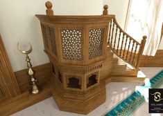 an elaborately carved wooden structure in the corner of a room next to a stair case