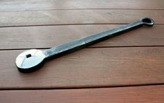 a wrench sitting on top of a wooden floor