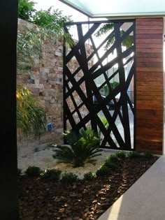 an entrance to a house with a wooden door and glass window on the outside wall