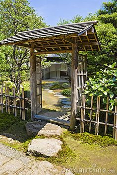 an outdoor area with rocks and trees in the foreground, surrounded by stone walkways