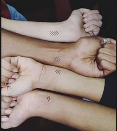 three people with matching tattoos on their arms