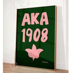 a framed poster with the words aka 1908 written in pink on a green background