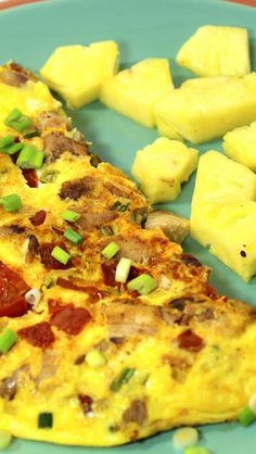 an omelet with pineapple slices on the side