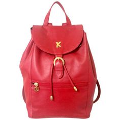 Introducing a rare masterpiece, red leather backpack from Paloma Picasso back in the 90's. Beautiful red color and condition! Featuring its iconic "X" and logo motifs on the golden hardware, and a large embossed logo on the exterior bottom.  Beautiful vintage condition with little damages. Clean interior linings. Made in Italy Measurement: W9.4"/14.5"(24cm at bottom/37cm at max) x H13"(33cm) x D7"(18cm) Straps(Adjustable): 21.2"-26"(54-66cm) 1 zipper pocket inside 1 zipper pocket outside Please Leather Backpack Outfit, 90s Backpack, Backpack Outfit, Golden Logo, Paloma Picasso, Classic Bags, Embossed Logo, Backpack Purse, Paloma