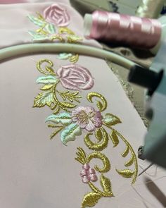 the embroidery is being worked on by someone