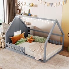 a child's bed with a little house on the top and pillows below it