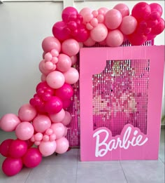 there is a pink frame with balloons in it and the word barbie written on it