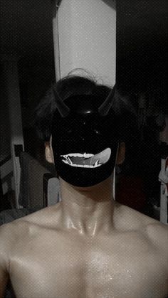 a man with no shirt wearing a black mask