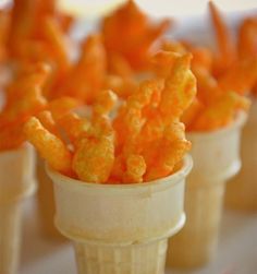 small cups filled with cheetos sitting on top of a table