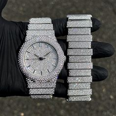 Step into elegance with this fully iced-out diamond watch and staggered bracelet set that mirrors genuine luxury watches. We utilize premium simulated diamonds crafted from high-refractive crystals, ensuring a sparkle that rivals authentic diamonds under the light! INCLUDES AN EASY-TO-USE SIZE ADJUSTMENT TOOL Specifications: - Gender: Men's - Case Size: 46mm - Sizing: 8.5-inch band - Bracelet Length: 9-inches (Non-adjustable) - Movement: Quartz Movement - Battery: Included - Adjustable: Watch Li Silver Diamond Watch With Bling, Silver Diamond Watch With Cubic Zirconia For Parties, Silver Cubic Zirconia Diamond Watch For Party, Silver Diamond Watch With Crystal For Parties, Silver Diamond Watch With Rhinestones And Crystal, Silver Crystal Diamond Watch For Parties, Silver Diamond Watch With Cubic Zirconia Bling, Silver Cubic Zirconia Iced Out Watches, Silver Diamond Watch Iced Out For Party