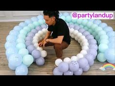 a man kneeling down in front of balloons