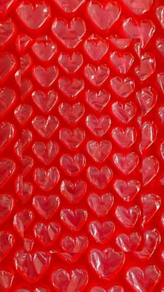 many red hearts are arranged in the shape of heart shapes, as well as on top of each other