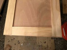 an unfinished cabinet door is being built in the process of being assembled with plywood