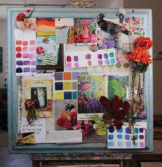 an easel is covered with many different pictures and flowers