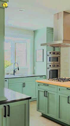 a kitchen with green cabinets and an oven