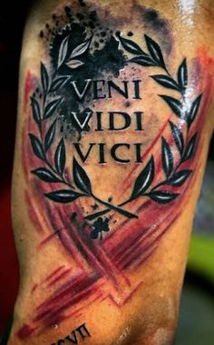 a man with a tattoo on his arm that says veni vidi vici